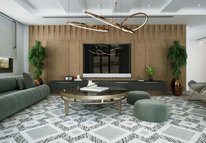 Un salon moderne avec un canapé vert, une table basse ronde et un tapis graphique. L'éclairage du salon est assuré par un lustre sculptural et des spots intégrés, créant une ambiance chaleureuse.