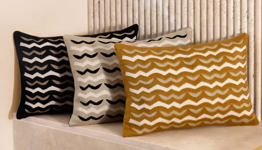 Trois coussins aux motifs ondulés, parfaits pour choisir quel tissu pour housse de coussin.