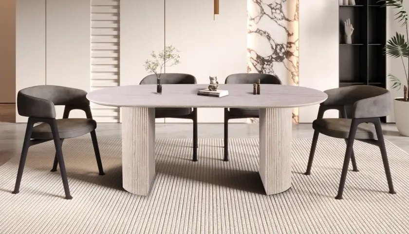 Table ovale moderne pour 8 personnes, aux dimensions généreuses, avec pieds sculpturaux et chaises grises confortables.