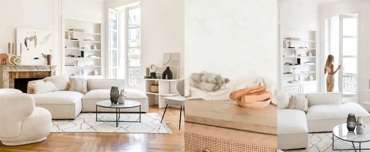 Un salon salle à manger moderne et épuré, avec un canapé blanc, une cheminée en marbre et des étagères remplies d'objets décoratifs.